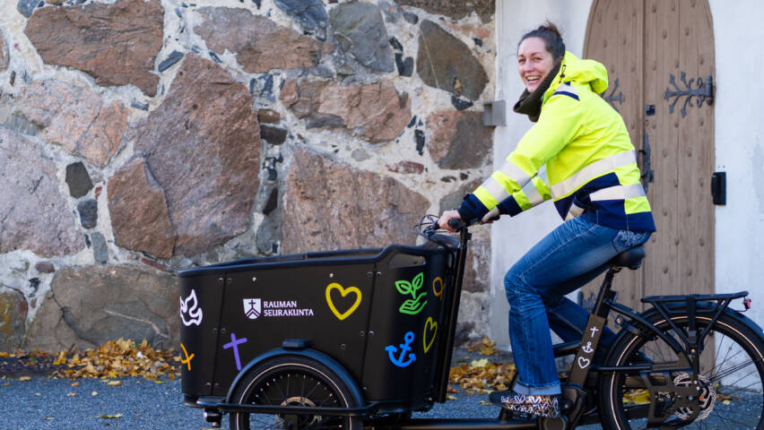 Henkilö pyöräilee tavarapyörällä